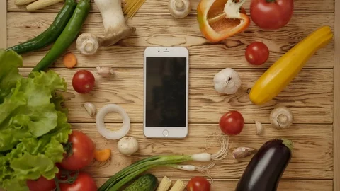 Faceless cook taking phone from kitchen counter with ingredients Stock Footage 119954821
