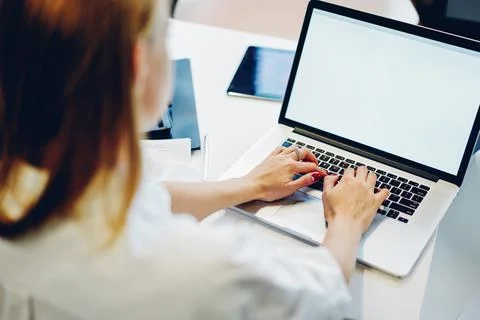 Faceless female freelancer working on computer in workplace Stock Photos