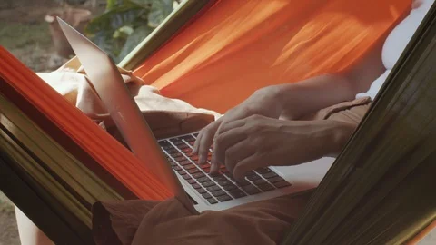 Faceless female hands typing notebook keyboard outdoors on summer nature Stock Footage 128475875
