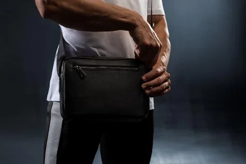 Faceless guy with a black bag over his shoulder Stock Photos