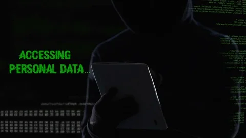 Faceless hacker cracking password and erasing all files database using tablet Stock Footage 84539425