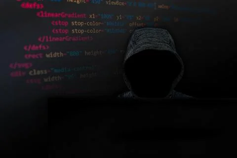 A faceless hacker works in front of a graphical interface of a monitor. Lines 스톡 사진