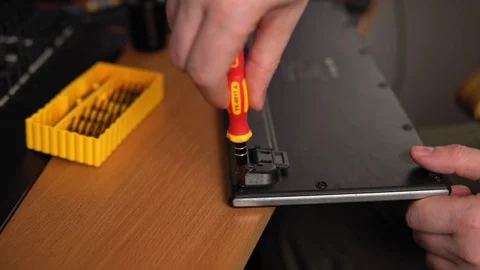 Faceless male master fixes keyboard in front of monitors Stock Footage 125446493