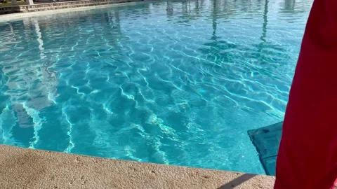 Faceless man catching garbage in the pool with a net. Stock Footage 169864683