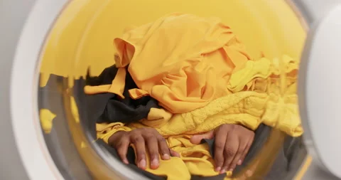 Faceless man fully covered with laundry touches fabric clothing poses from Stock Footage 156632157