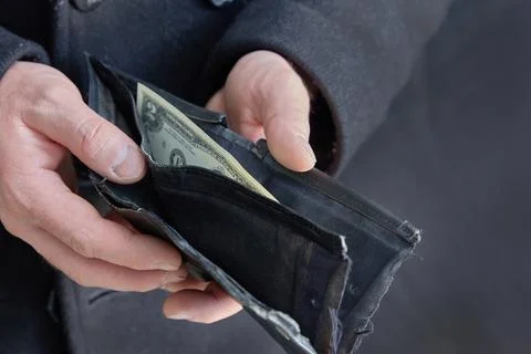 The faceless man opened the wallet containing the last bill. Crisis. Stock Photos