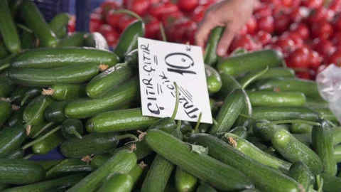Faceless person puts vegetables in plastic bag Stock Footage 221302315