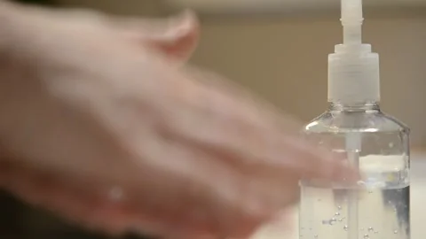Faceless Person Using Hand Sanitizer in Office Workplace Hygiene Safety Stock Footage 308038961