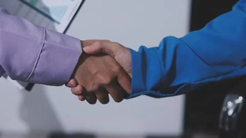 Faceless two men shake hands in warehouse, business agreement in storage fa.. Stock Footage 336014258