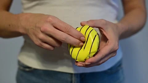 Faceless woman holding a donut imitating sexual intercourse. A metaphor for Stock Footage 144046887