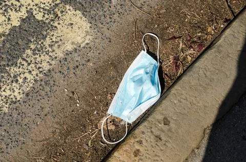 Facemask in gutter Stock Photos