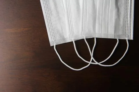 Facemask on the wooden table Stock Photos