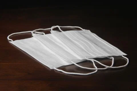 Facemask on the wooden table Stock Photos
