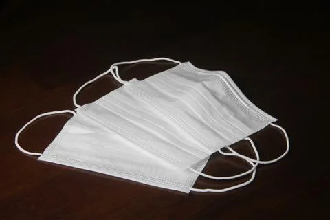 Facemask on the wooden table Stock Photos