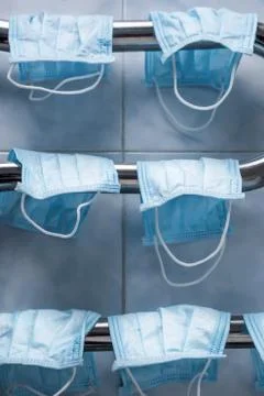 Facemasks drying on the coil. Double-use of protective mask. Saving money on Stock Photos