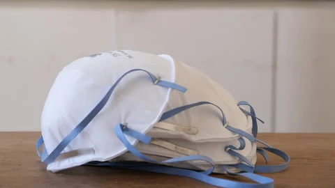Facemasks lying on table. Slider shot. Stock Footage 132131397