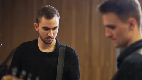 Faces and Hands of Two Young Men Playing Guitars Stock Footage 72225003