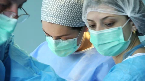Faces of doctors during operation Stock Footage 54968094