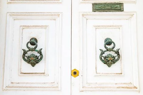 Faces on door knockers Stock Photos