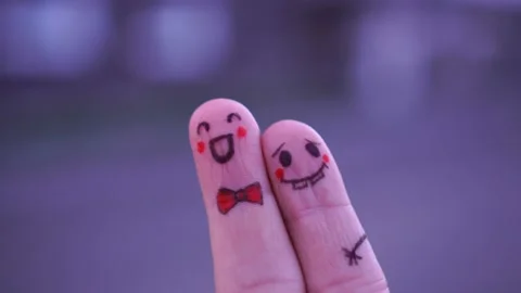 Faces drawn on the fingers of a man Stock Footage 117437628