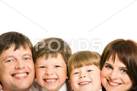 Faces of four family members laughing and looking at camera Stock Photos