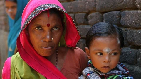 Faces of a mother and her child in a rural village in IndiaStock Footage