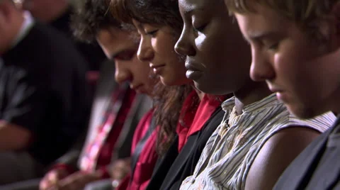 Faces of seated communicants partaking of the bread during Communion Stock Footage 59532101