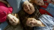 Faces Of Smiling Family Lying On Floor Stock Footage