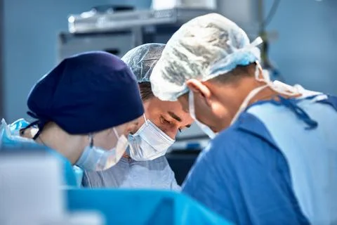 Faces of surgeons in the operating room during the operation, modern medicine Stock Photos