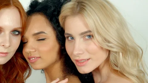 Faces of three different women together, smiling and looking at camera Video stock 88886991