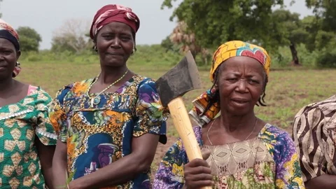 Faces of women farmers with farm tools in Chad, Africa Stock Footage