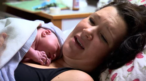 The faces of a young mother and her newly-delivered baby boy Stock Footage 59243873
