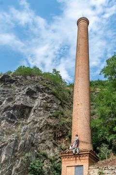 A faceted chimney with funny dummies of workers Stock Photos
