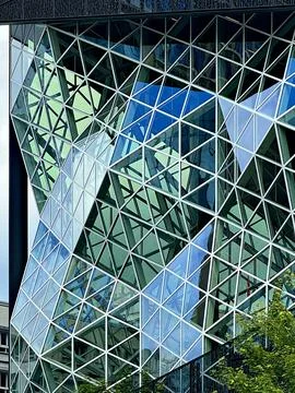 Faceted triangular glass facade of a modern building in Berlin, Germany Stock Photos