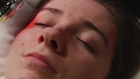 Facial beauty procedure using modern home device emitting red LED light Stock Footage 344877044