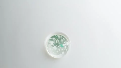 Facial cleanser, macro. Transparent peeling gel with bubbles and blue granu.. Stock Footage 267061055