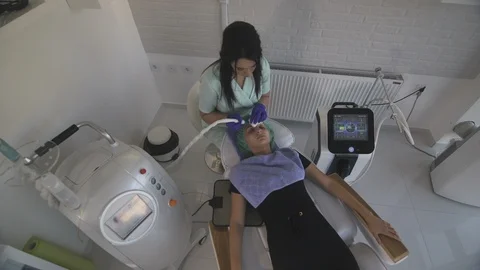 Facial cleanup, beautician using device for face peeling, beauty spa, crane shot Stock Footage 108230794