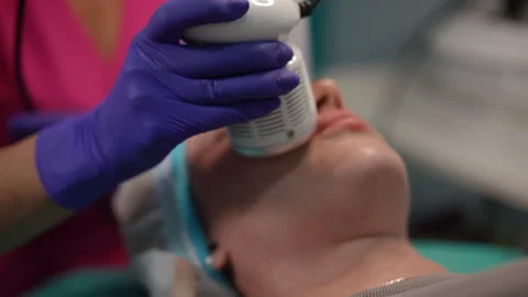 Facial contouring procedure with modern device in professional skincare clinic Stock Footage 311366799