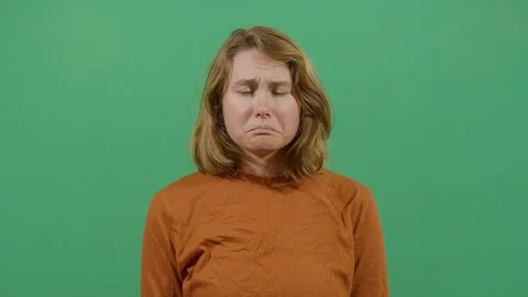 Facial expression of a woman pouting studio isolated shot against green screen Stock Footage 117980421