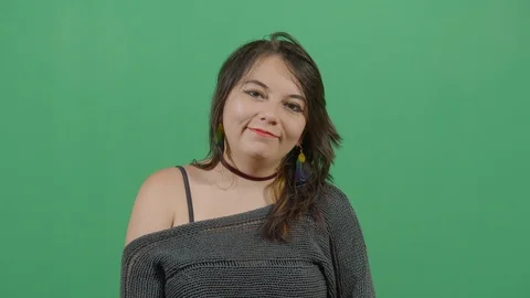 Facial expression of a woman smiling studio isolated shot against green screen Stock Footage 117978336