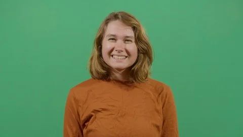 Facial expression of a woman smiling studio isolated shot against green screen Stock Footage 117980400
