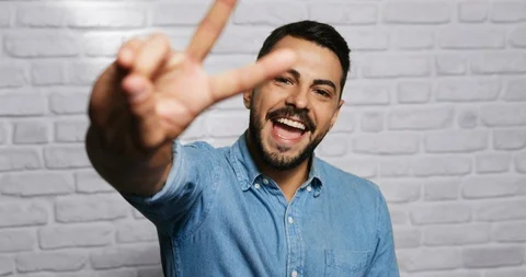 Facial Expressions Of Young Beard Man On Brick Wall Stock Footage 87453668