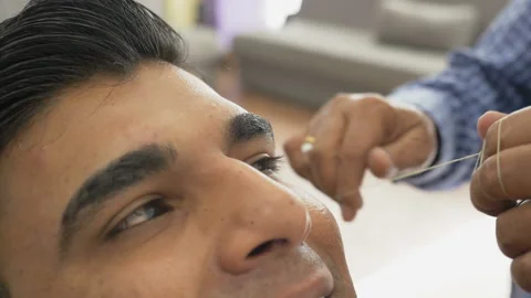 Facial hair removal using threading technique Stock Footage 116396124