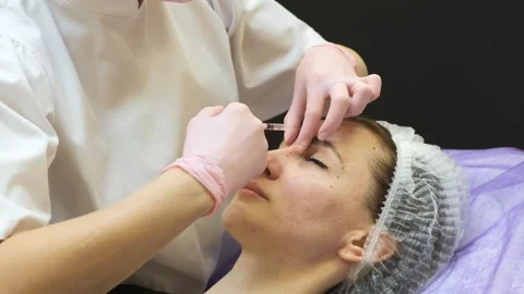 Facial injection procedure for wrinkle reduction in aesthetic clinic environment Stock Footage 333239673