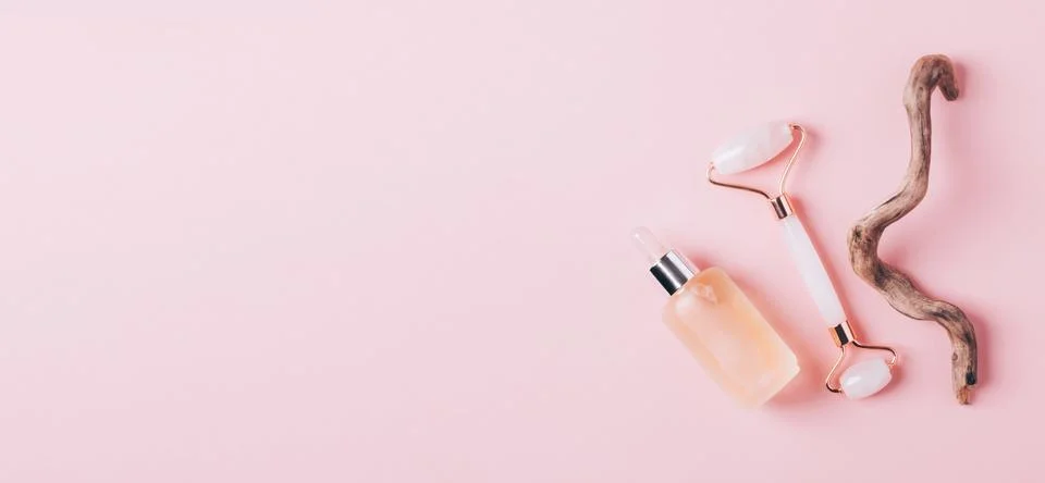 Facial massage set roller scraper guasha pink background Stock Photos