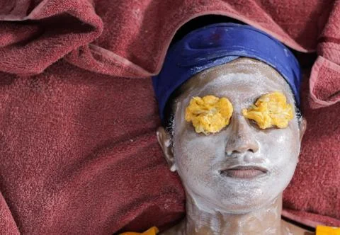 Facial pack mask applied on face of a lady with hair band with eyes closed wi Stock Photos