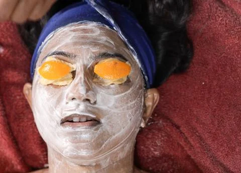 Facial pack mask applied on face of a lady with hair band with eyes closed wi Stock Photos