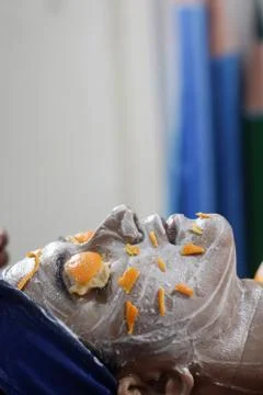 Facial pack mask applied on face of a lady with hair band with eyes closed wi Stock Photos