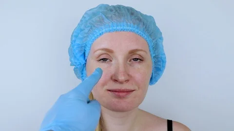 Facial plastic surgery or facelift, facelift, face correction. A plastic surgeon Stock Footage 104924997