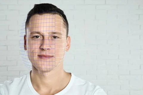 Facial recognition system. Man with digital biometric grid against brick wall Stock Photos